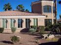Attractive exterior with desert landscaping featuring manicured shrubs and a tile roof at 3318 N Decatur Blvd # 2077, Las Vegas, NV 89130