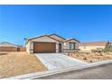 Charming single story home with a two car garage, low maintenance desert landscaping, and desert skies at 3665 E Garfield Dr, Pahrump, NV 89061