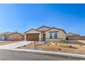 Charming single story home with a two car garage and low maintenance desert landscaping at 3665 E Garfield Dr, Pahrump, NV 89061