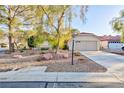 Inviting single-story home with a well-maintained front yard and a two-car garage, offering curb appeal at 5601 Cavalier Cir, Las Vegas, NV 89130