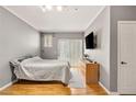 Simple bedroom showcases a gray wall color, light wood flooring, slider door and a minimalist aesthetic at 5855 Valley Dr # 1080, North Las Vegas, NV 89031