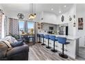 Modern kitchen with stainless steel appliances and bar stool seating facing the living area with mountain views at 7241 Indian Creek Ln # 203, Las Vegas, NV 89149