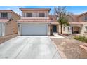 Two-story home featuring a red tile roof and a two-car garage at 7437 Treasure Chest St, Las Vegas, NV 89139