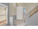 Inviting foyer with tile floors, staircase, and natural light at 7437 Treasure Chest St, Las Vegas, NV 89139