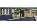 View of modern townhomes with rooftop balconies, offering a glimpse of the city skyline in the background at 8175 Caldera Creek St, Las Vegas, NV 89113