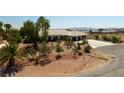 Beautiful single-story home with lush landscaping creating a serene and inviting curb appeal at 8290 Gagnier Blvd, Las Vegas, NV 89113