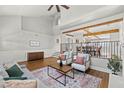 Cozy living room with high ceilings, wood beams, fireplace, and adjacent dining area at 8820 Fall Green Ave, Las Vegas, NV 89129