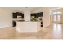 Open kitchen with dark cabinets, granite countertops, and stainless steel appliances at 9252 Oxbow Lake Ave, Las Vegas, NV 89149