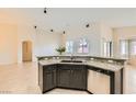 Kitchen features granite countertops, stainless steel appliances, and a breakfast bar at 9252 Oxbow Lake Ave, Las Vegas, NV 89149