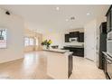 Bright, open kitchen with black cabinets, granite countertops, and modern appliances at 9252 Oxbow Lake Ave, Las Vegas, NV 89149