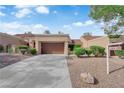 Charming one-story home features an attached garage, desert landscaping, and a well-maintained exterior at 9424 Gold Mountain Dr, Las Vegas, NV 89134