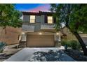 Charming two-story home with a two-car garage with stone accents and dark shutters at 10312 Glimmering Star Dr, Las Vegas, NV 89178