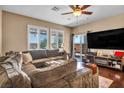Cozy living room with a plush sectional sofa, fireplace, and sliding glass doors at 10312 Glimmering Star Dr, Las Vegas, NV 89178