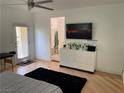 Spacious bedroom with hardwood floors and a glimpse of the en suite bathroom at 1525 Spiced Wine Ave # 14101, Henderson, NV 89074