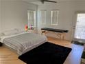 Bright bedroom featuring wood floors, a large bed, and natural light at 1525 Spiced Wine Ave # 14101, Henderson, NV 89074