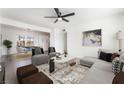 Spacious living room featuring modern decor, open concept design and a view into the dining area at 2 Utah Way, Henderson, NV 89015