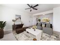 Bright living room with stylish furnishings, modern ceiling fan, and an open concept design at 2 Utah Way, Henderson, NV 89015