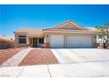 Inviting single-story home with a two-car garage, desert landscaping, and well maintained driveway at 218 Red Coral Dr, Henderson, NV 89002