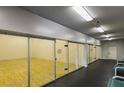Indoor racquetball court with finished wood floors and paneled glass walls in a recreation area at 2200 S Fort Apache Rd # 2217, Las Vegas, NV 89117