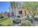 View of the side of a home with well-maintained landscaping and a privacy fence at 2261 Dalton Ridge Ct, North Las Vegas, NV 89031