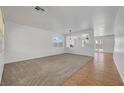 Spacious living room with neutral carpet, white walls, and ample natural light from large windows at 2261 Dalton Ridge Ct, North Las Vegas, NV 89031