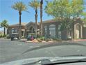 Exterior of community clubhouse with golf carts parked and mature palm trees at 2900 Sunridge Heights Pkwy # 418, Henderson, NV 89052