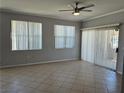 Bright living room with tile flooring, ceiling fan, and sliding glass doors at 2900 Sunridge Heights Pkwy # 418, Henderson, NV 89052