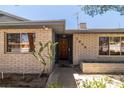 Close-up of house with desert landscaping, brick exterior, and unique house number design at 3090 Westwind Rd, Las Vegas, NV 89146