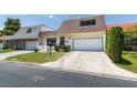 Charming home featuring well-maintained landscaping, a two-car garage, and a welcoming entrance at 3785 Decade St, Las Vegas, NV 89121
