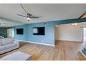 Spacious living room with sleek wood floors, modern lighting, and large windows for natural light at 3785 Decade St, Las Vegas, NV 89121