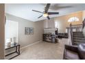 Spacious living area featuring a fireplace, staircase, and tile flooring, ideal for comfortable living and entertaining at 433 Jubilation Dr, Las Vegas, NV 89145