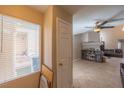 Bright living room with modern ceiling fan and tile flooring, showcasing an open concept and abundant natural light at 433 Jubilation Dr, Las Vegas, NV 89145