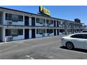 White two-story building with parking, showing many numbered doors and barred windows along its length at 4600 Paradise Rd # 16, Las Vegas, NV 89169