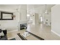Open-concept living space with tile floors, modern fireplace, and seamless flow to dining and kitchen areas at 4753 Carefree Dr, Las Vegas, NV 89122