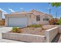 Inviting single-story home featuring a tile roof, front desert landscaping, and a two-car garage at 5139 Zapata Ln, North Las Vegas, NV 89031