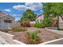 Home's front yard showcasing low-water landscaping, rock features, mature trees, and a desert aesthetic at 5139 Zapata Ln, North Las Vegas, NV 89031