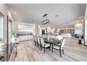 Spacious dining area with a large table, modern lighting, and open layout connecting to the kitchen and living spaces at 5438 Sierra Brook Ct, Las Vegas, NV 89149