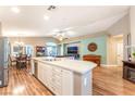 Open concept kitchen and dining area with center island, stainless appliances, and hardwood floors at 5733 Dazzling Sparks St, North Las Vegas, NV 89031