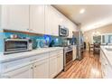 Modern kitchen featuring stainless steel appliances, granite counters, and a stylish backsplash at 5733 Dazzling Sparks St, North Las Vegas, NV 89031