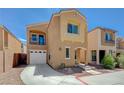 Charming two-story home with a balcony, attached garage, neutral stucco, and low-maintenance landscaping at 6048 Aripeka St, Henderson, NV 89011
