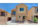 Charming two-story home with a balcony, attached garage, neutral stucco, and low-maintenance landscaping at 6048 Aripeka St, Henderson, NV 89011
