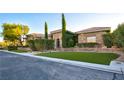 Attractive single-story home with manicured landscaping, artificial turf, and stone accents at 6120 Kings Brook Ct, Las Vegas, NV 89149
