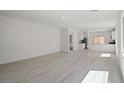 Bright, open-concept living space with sleek floors and neutral walls at 6755 Violet Cascade Ave, Las Vegas, NV 89156