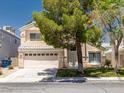 Inviting two-story home featuring a two-car garage and well-maintained front yard at 7924 Mcdowell Dr, Las Vegas, NV 89129