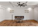 Living area highlighting a modern fireplace, floating shelves, and hardwood floors at 8753 Mann St, Las Vegas, NV 89139