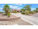 Attractive single story home with a long driveway, desert landscaping, and an attached garage at 8808 Homestead Rd, Las Vegas, NV 89143
