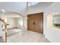 Spacious foyer featuring high ceilings, tile flooring, and a grand double-door entrance at 902 Cripple Creek Ct, Henderson, NV 89014