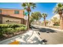 Entrance to the Maplewood community, showcasing lush landscaping, palm trees, and a welcoming stone sign at 9122 Mountain Maple Ct, Las Vegas, NV 89148