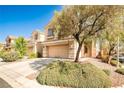Well-kept two-story home featuring a two-car garage and mature landscaping in a quiet neighborhood setting at 9122 Mountain Maple Ct, Las Vegas, NV 89148