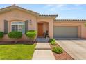 Inviting front exterior with a well-kept lawn, walkway, and a charming front door at 10463 Pioneer Park Ave, Las Vegas, NV 89135